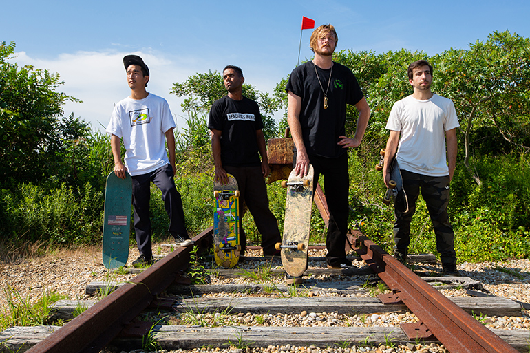 Tohmi Shiroyama, Bartholomew Schwarz, Pat Lane and Lenny Giannantoni at the end of railroad tracks in Montauk with skateboards