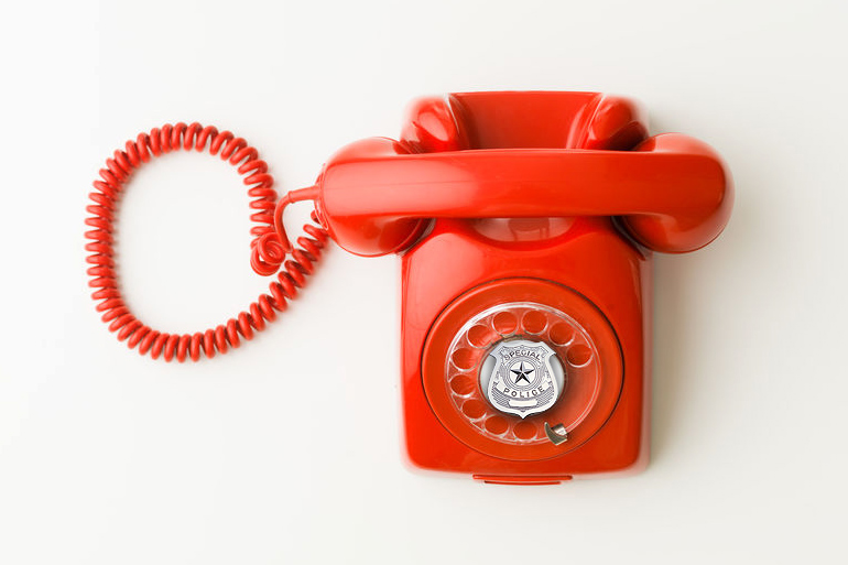 Hamptons Police Department red rotary phone with badge at center