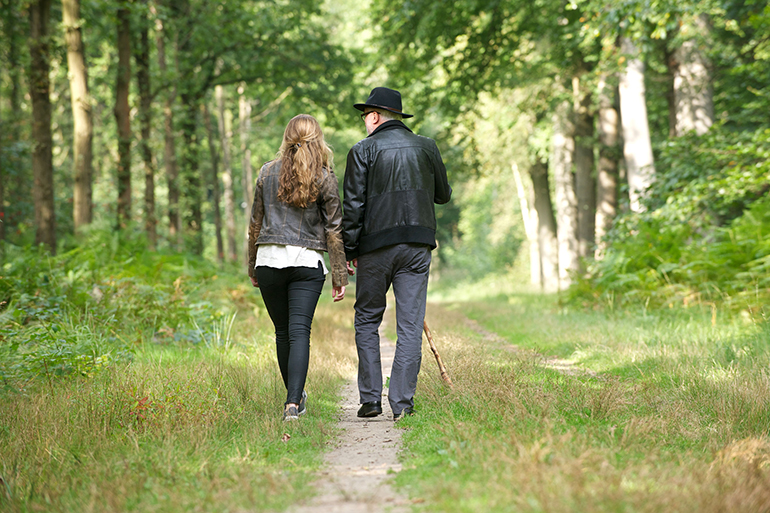 Portrait of a father walking with daughter in the forest