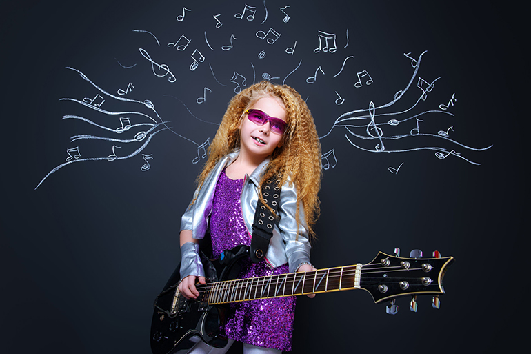 Little rock star singing with her electric guitar over musical background. Music concept.