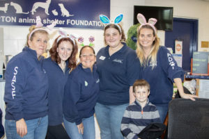 The Adoption Coordinators team poses with Declan, age 6