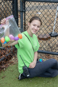 Lexy, age 15, helps set up the Easter egg hunt for the dogs