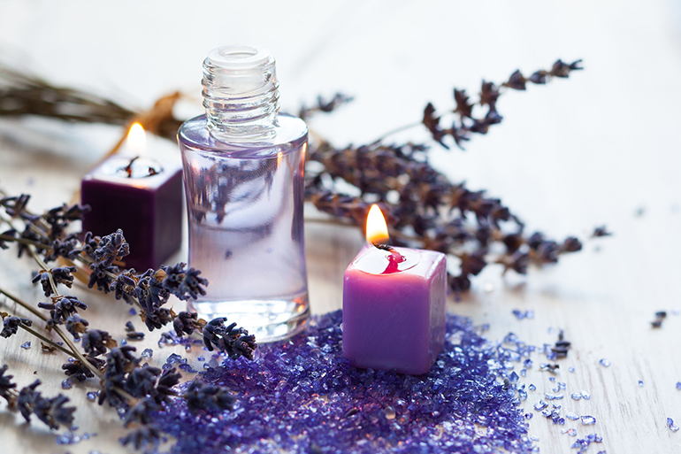 Dried lavender flowers with a bottle of essential oil