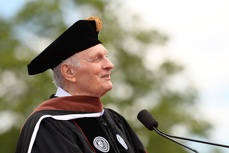 Alan Alda at the podium of Stony Brook University 2019 commencement