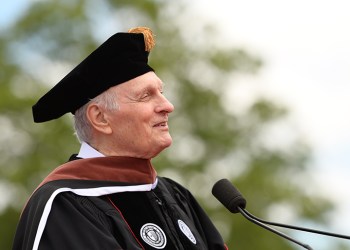 Alan Alda at the podium of Stony Brook University 2019 commencement
