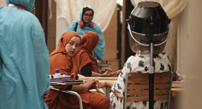 Verida working in her grandmother's beauty parlor in "Flesh Out." Amal is reflected in the mirror.