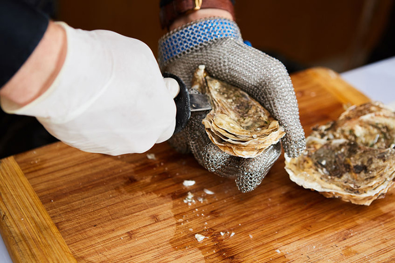 Shucking oyster hands