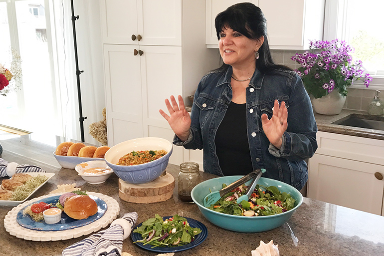 Andrea Anthony filming "Eat, Drink and Bake with Andrea" at home