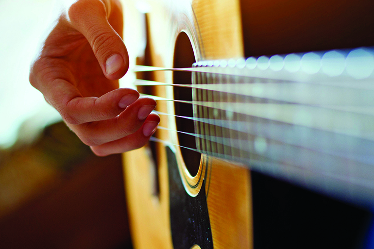 play acoustic guitar, close up of the hands