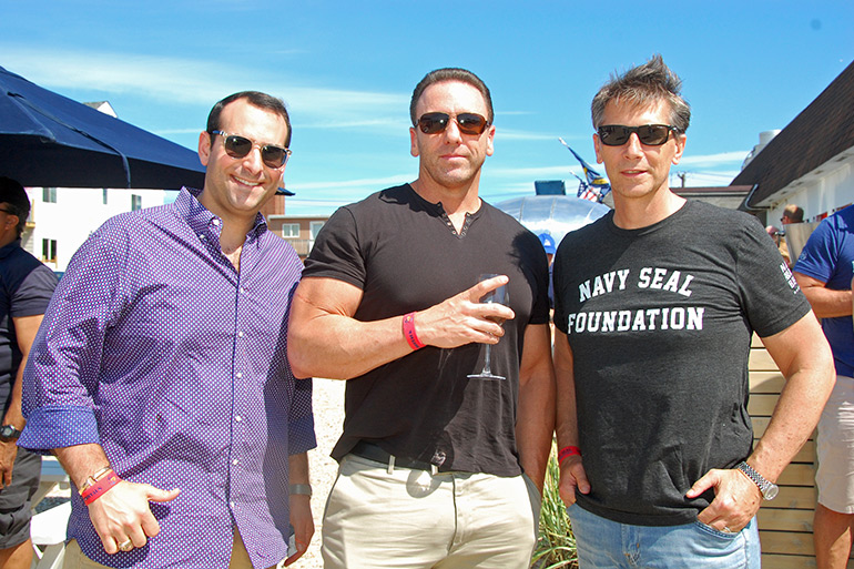 Navy SEAL Tony Repinski (center) will speak at Navy Beach on Saturday