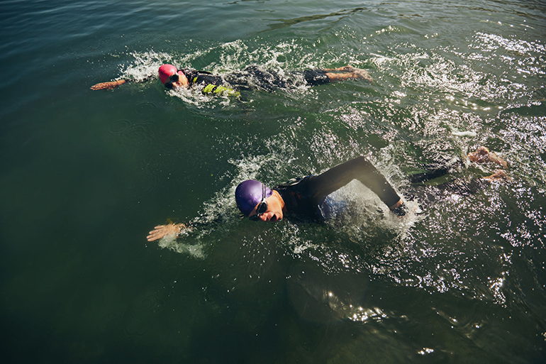 Competitors fighting in the swim event of a triathlon competition.