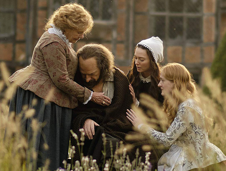Shakespeare is comforted by his wife Anne and daughters Judith and Susanna in "All Is True"