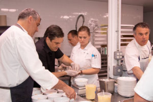 Teamwork in the kitchen as chefs prepare each course