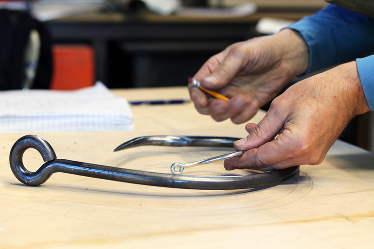 John Battle creates metal fishhooks 