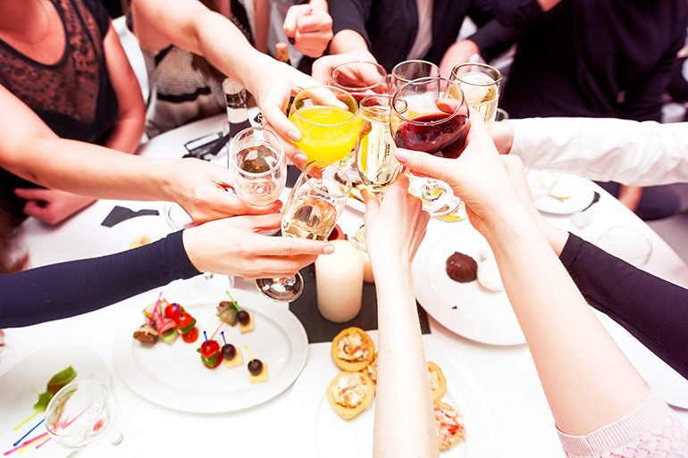 Clinking glasses with alcohol and toasting, party. Congratulations to the event. Cheerful party friends