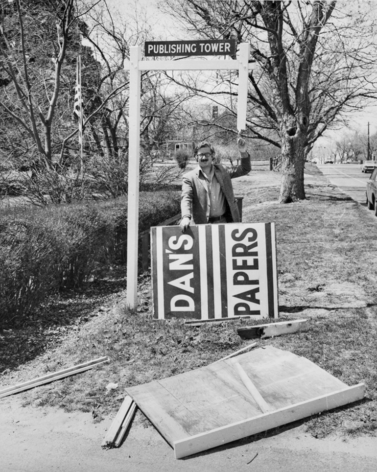 Dan Rattiner with his Dan's Papers sign