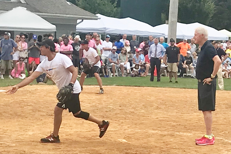 Bill Clinton umpires at the 2019 Artists & Writers Game