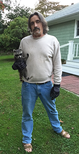 Dell Cullum with a local raccoon, Photo" Courtesy Cullum