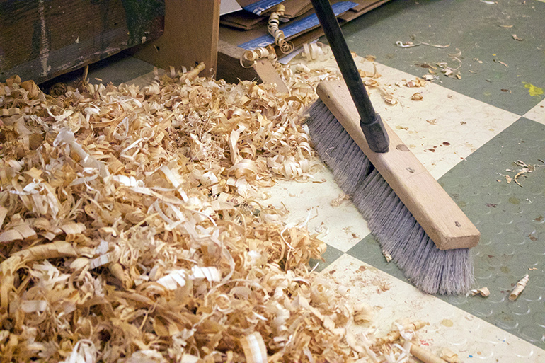 Sweeping up sawdust for later use at Grain Surfboards