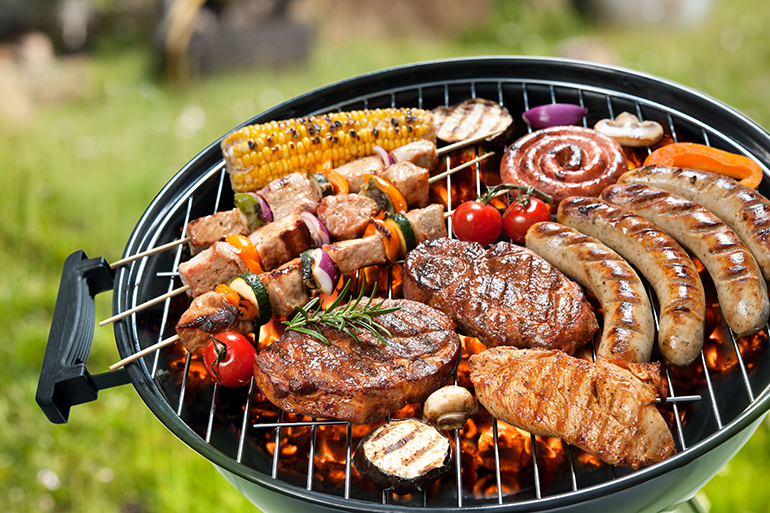 Assorted delicious grilled meat with vegetable over the coals on a barbecue