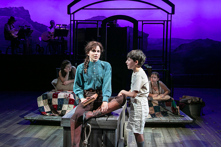 Little Jake (Will Hantz) teaching his big sister Annie (Alexandra Socha) how to read, Photo: Lenny Stucker