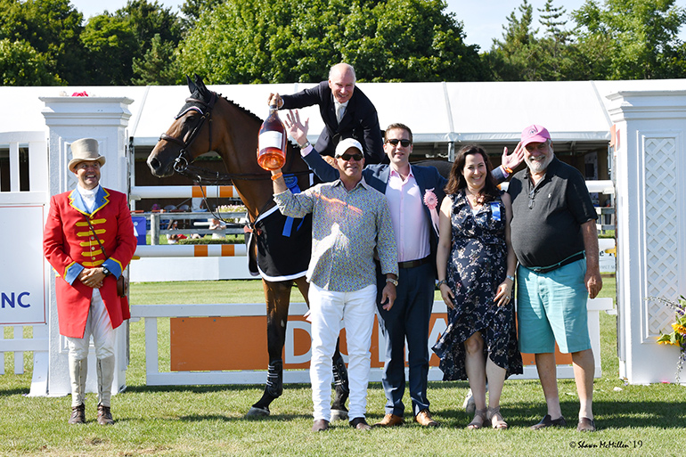 Mario Deslauriers, on Bardolina 2, celebrates his 2019 Hampton Classic Grand Prix victory with champagne