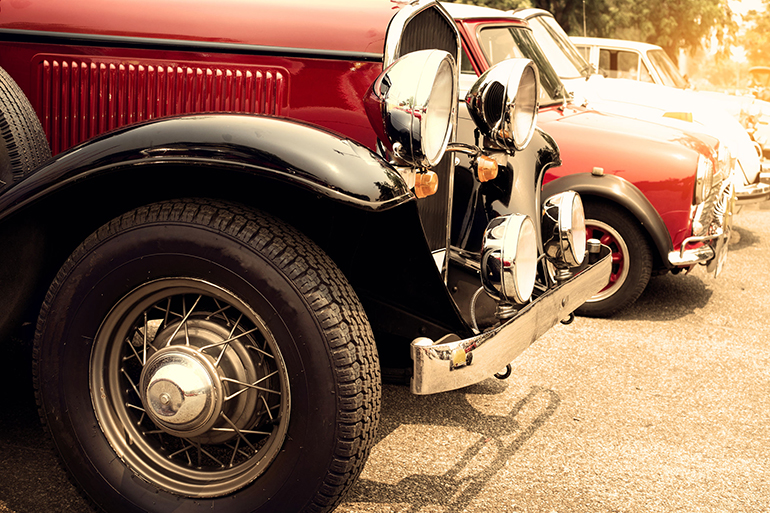 Detail of front vintage car wheels and headlight - Classic vehicles