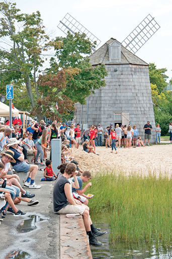 Festival-goers gather to watch the famous whaleboat races,