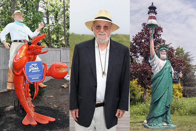 Dan and his statues, one with him riding a lobster, the other with him as the Statue of Liberty