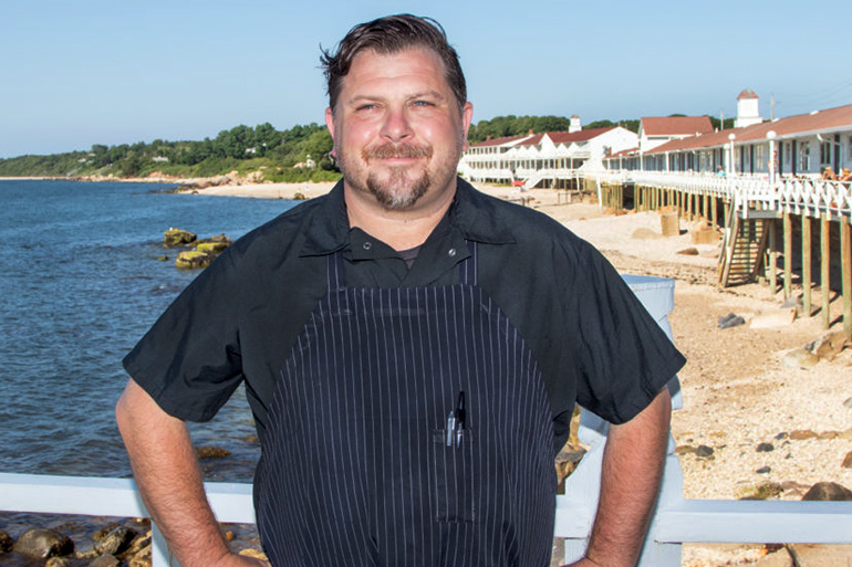 Matty Boudreau standing with hands on hips on the deck at The Halyard at Sound View Greenport