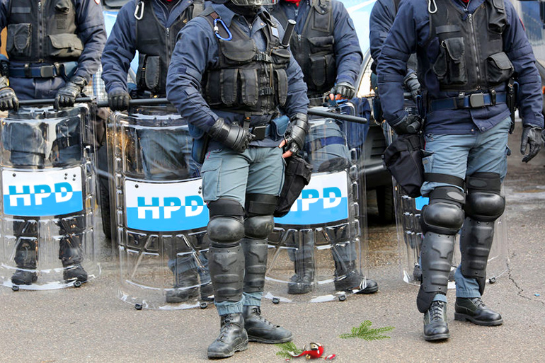 Hamptons Police riot troops with broken Christmas ornament and fir sprigs