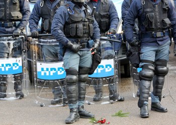 Hamptons Police riot troops with broken Christmas ornament and fir sprigs