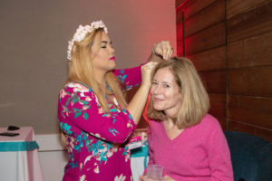Cindy Frankel applying a pink hair extension to Jamie McKenna