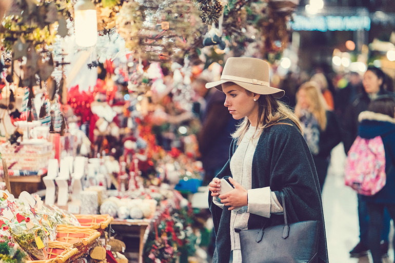 Fashionable woman choosing gifts for Christmas