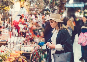 Fashionable woman choosing gifts for Christmas