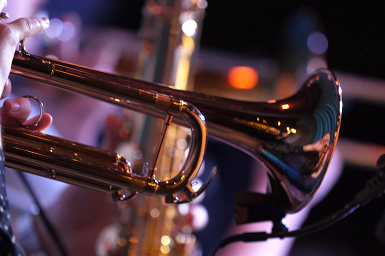 Pipes in the hands of musicians. Musicians playing wind instruments