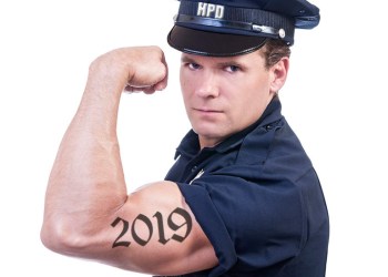 Hamptons Police Department officer flexing bicep with 2019 tattoo