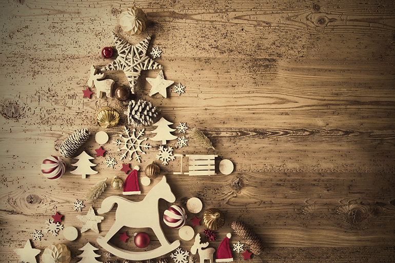 Christmas Decoration Forming Shape Of Christmas Tree. Decoration Like, Rocking Horse, Santa Hat, Fri Con And Christmas Ball Ornament. Retro Brown Wooden Background With Copy Space