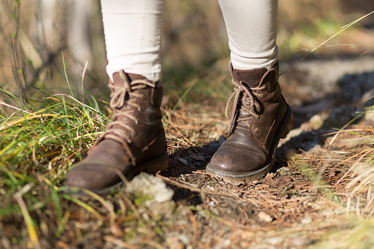 feet in shoes on a forest path