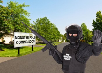 Hamptons Police in riot gear prepare for the Monster Pole on quiet suburban street
