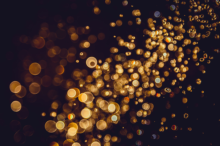 Defocus bokeh glitter gold vintage lights dark background