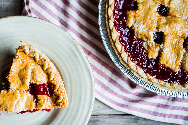 Homemade cherry pie on rustic background
