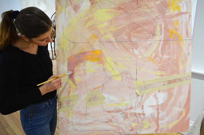 Isadora Capraro painting a new yoga-themed piece