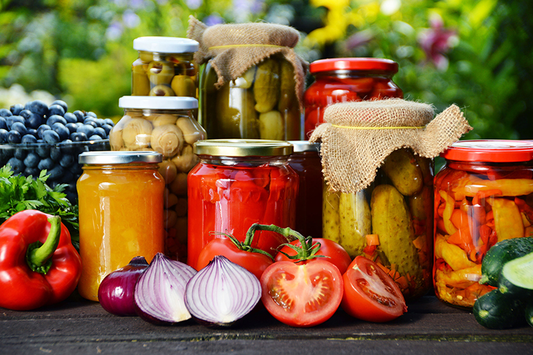 jars of pickled vegetables in the garden.