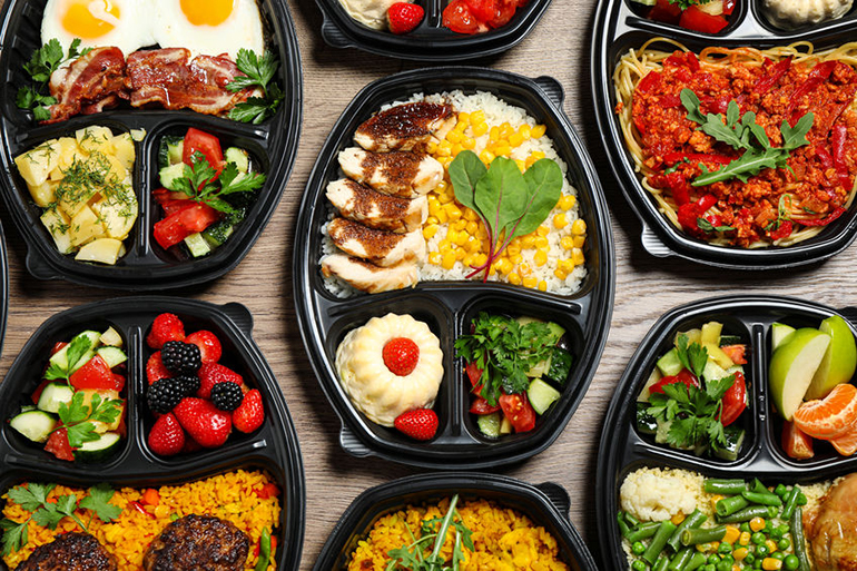 Good takeout Lunchboxes with different meals on table, flat lay. Healthy food delivery