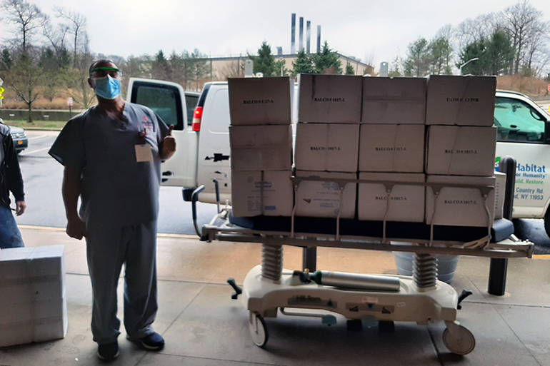 Habitat for Humanity of Suffolk delivers masks and coveralls to Stony Brook University Hospital with a thumbs-up