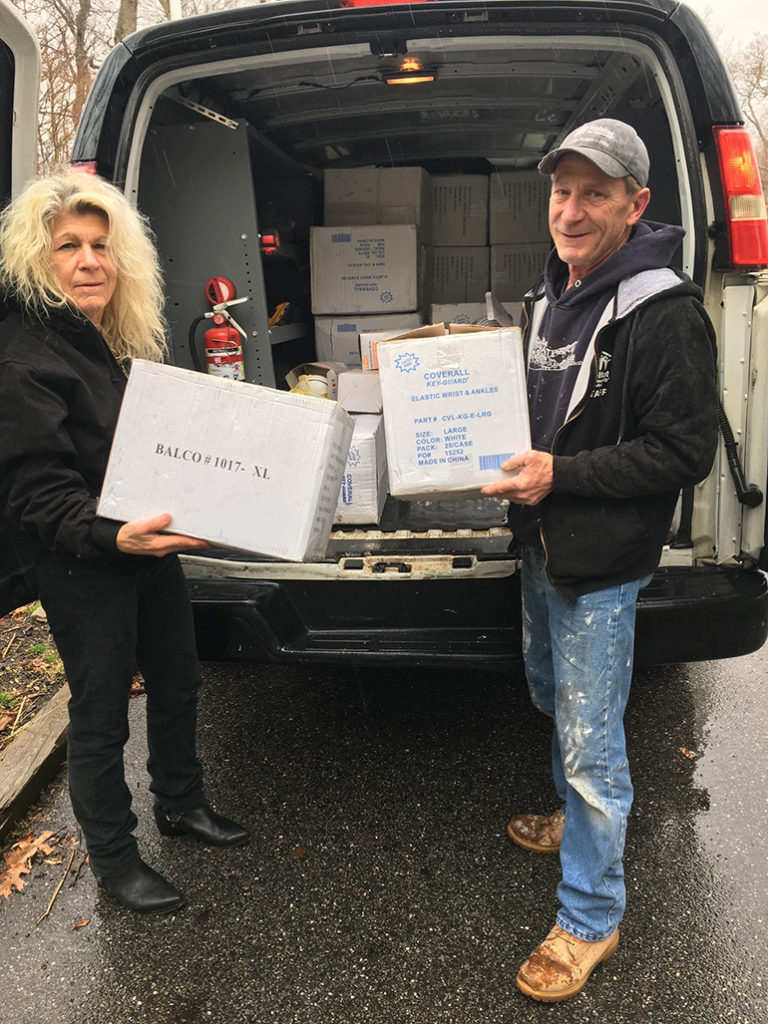 Habitat for Humanity of Suffolk staff pull boxes of masks and coveralls out of van to donate at Stony Brook University Hospital