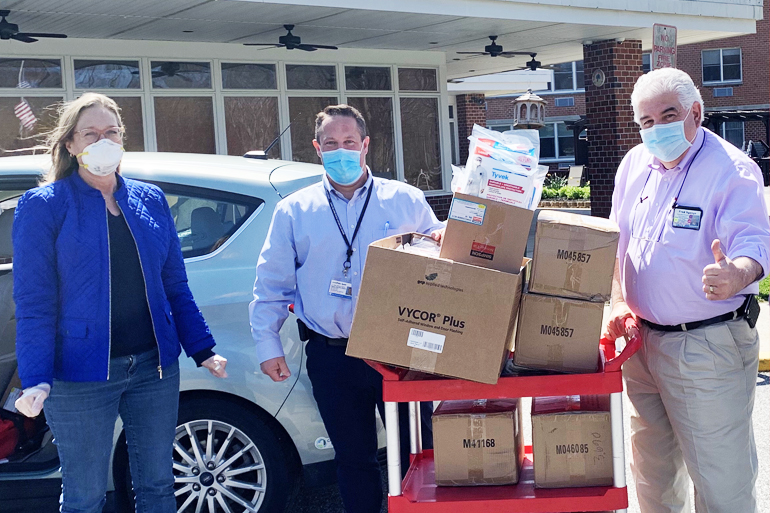 Bridget Fleming, Jonathan Spier and Fred Sganga delivering coveralls donated by One Source Tool Supply and Riverhead Building Supply