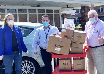Bridget Fleming, Jonathan Spier and Fred Sganga delivering coveralls donated by One Source Tool Supply and Riverhead Building Supply