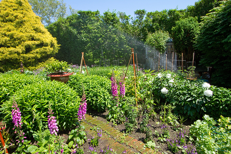 RB Irrigation sprinkler system waters Hamptons flower garden